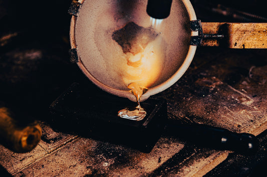 Melting gold in a crucible on a jewelller's bench